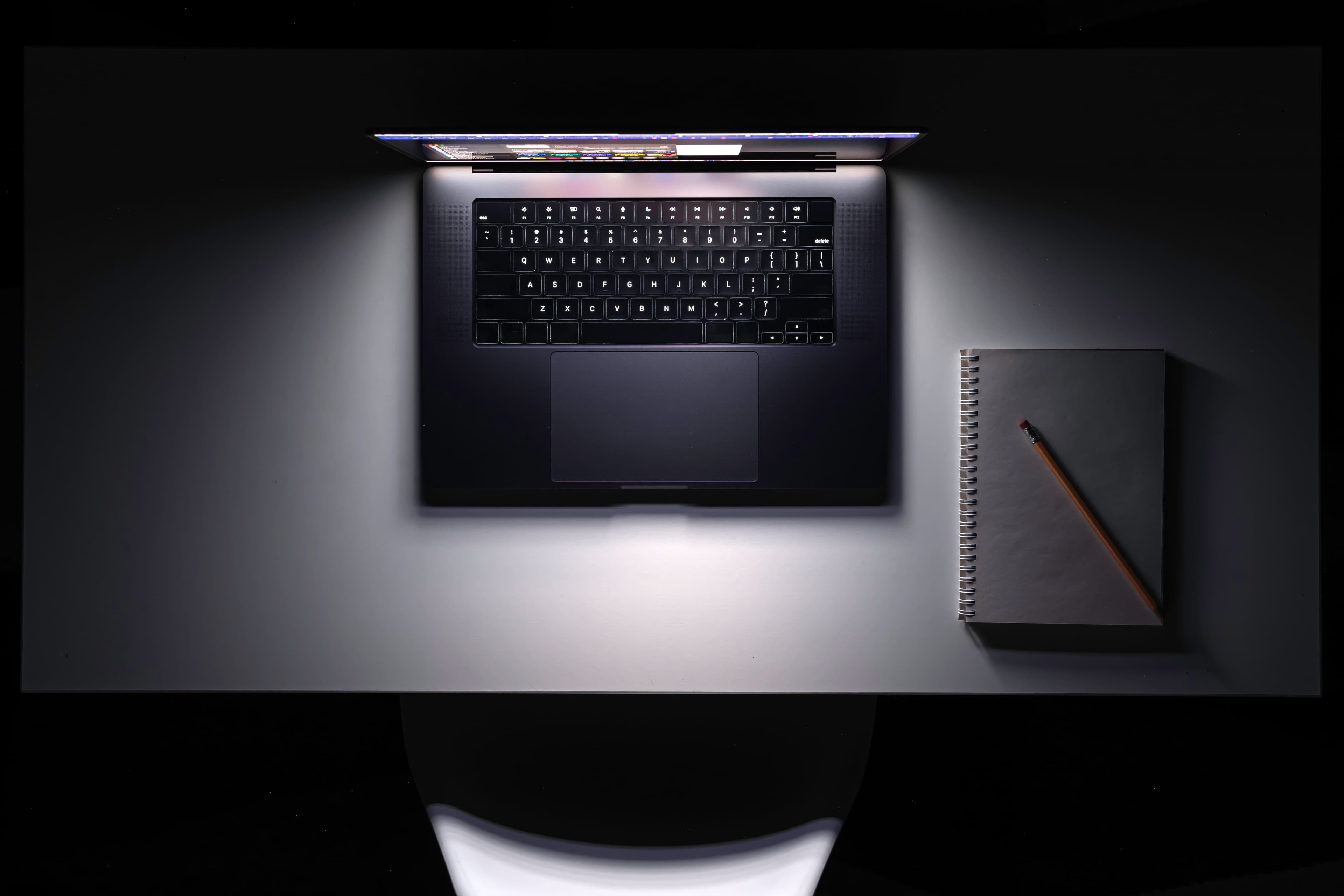 Laptop glowing at night — manage from anywhere